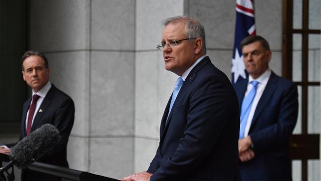 Scott Morrison, centre, with Health Minister Greg Hunt, left, and Chief Medical Officer Brendan Murphy, has warned that opening up the economy involves risk. Picture: AAP