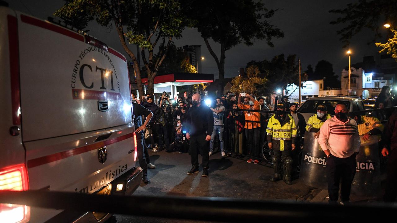 Member's of the Technical Investigation Team transport Hawkins’ body from the hotel. Picture: AFP