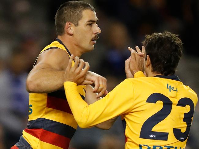 MELBOURNE, AUSTRALIA - APRIL 11: Taylor Walker of the Crows and Shane McAdam of the Crows celebrate during the 2021 AFL Round 04 match between the North Melbourne Kangaroos and the Adelaide Crows at Marvel Stadium on April 11, 2021 in Melbourne, Australia. (Photo by Michael Willson/AFL Photos via Getty Images)