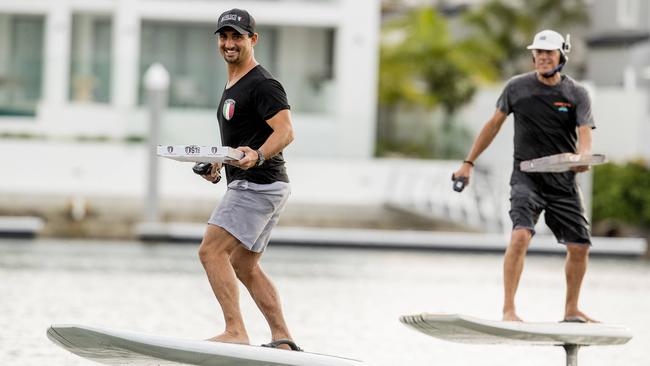 Manager of Alfresco Italian Raffaele Velardo and Vasco Vellez from eFoil GC are delivering pizzas via Coast waterways on electric surfboards. Picture: Jerad Williams