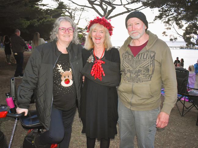 Pauline Crimmins, Clare Murphy and Bruce Crimmins getting festive at the Phillip Island Christmas Carols by the Bay at the Cowes Foreshore on Tuesday, December 10, 2024. Picture: Jack Colantuono