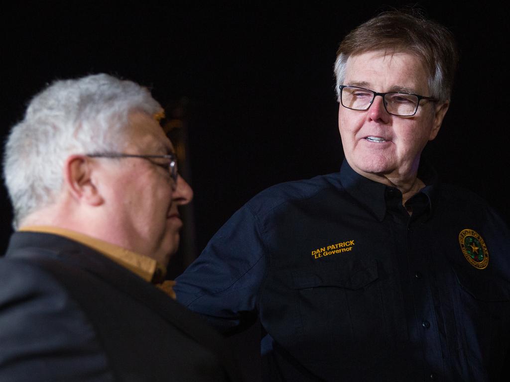 Lt. Gov. Dan Patrick, right, with West Freeway Church of Christ senior preaching minister Britt Farmer following a fatal shooting at his church. Picture: AP