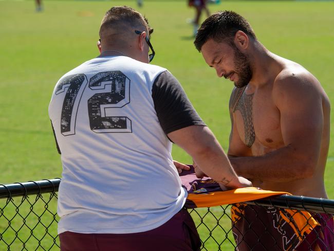 Brisbane captain Alex Glenn signs a fan’s Broncos shirt. Picture: Che Chorley