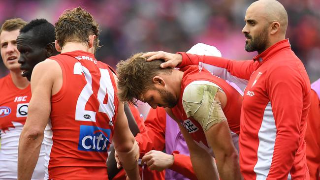 Alex Johnson is consoled by Swans assistant coach Rhyce Shaw after his latest devastating  injury. Picture: AAP