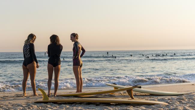 Women heading out for a morning surf at Cabarita Beach. Picture: Tom Park