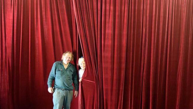 CURTAIN'S UP: Christopher Desgrand and Judith Flitcroft with the newly installed curtain at the Stanthorpe Little Theatre just in time for Guys and Dolls. Picture: Contributed