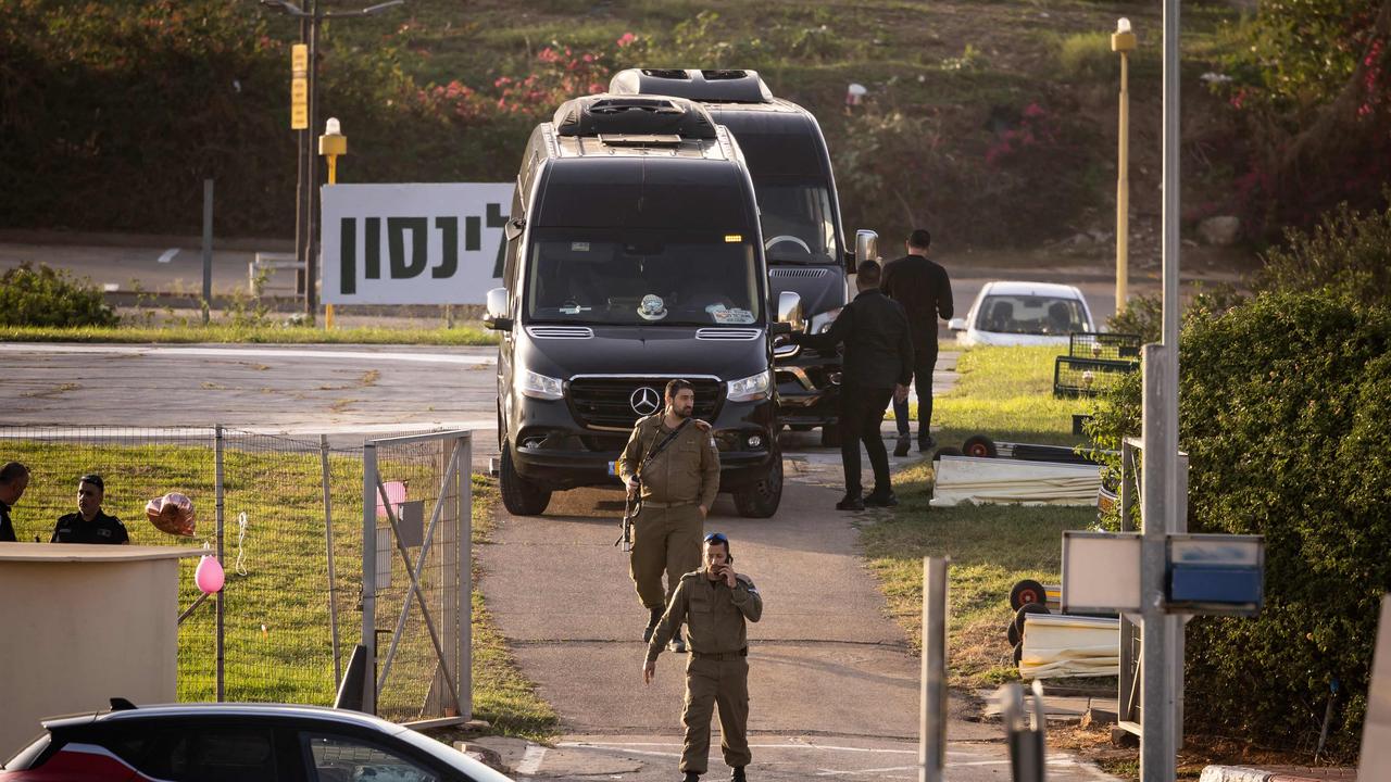 Israeli security forces stand next to buses waiting at the helipad of Tel Aviv's Schneider medical centre on November 24, 2023, amid preparations for the release of Israeli hostages. Picture: AFP