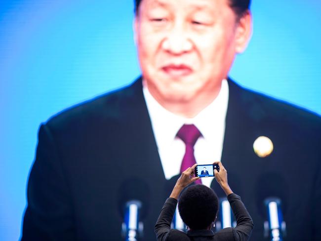 China's President Xi Jinping is seen on a big screen in the media centre as he speaks at the opening ceremony of the first China International Import Expo (CIIE) in Shanghai on November 5, 2018. - President Xi Jinping vowed on November 5 to open access to China's economy, while delivering a veiled rebuke to the Trump administration, as he kicked off an import fair amid growing foreign accusations that his government was backtracking on reform pledges. (Photo by Johannes EISELE / AFP)