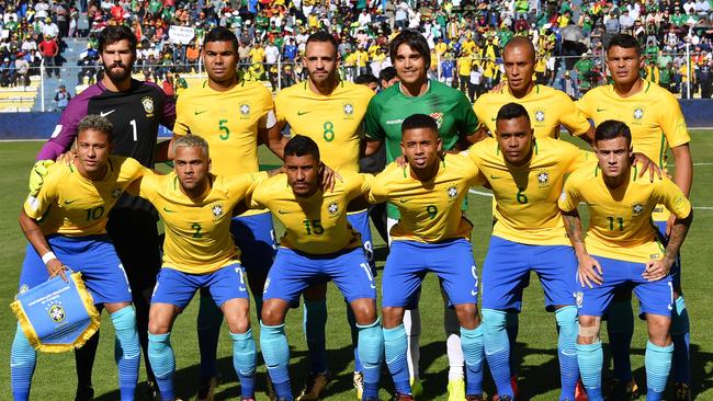 Brazil pose for a team photo with Bolivia’s striker.