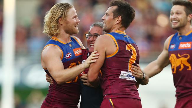 Brisbane coach Chris Fagan celebrates the Lions epic win over the Cats with Daniel Rich and Luke Hodge. Picture: Getty Images