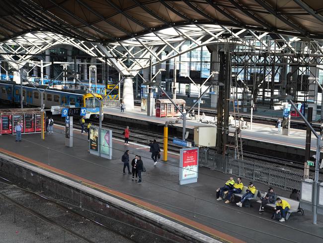 Commuters are seen at Southern Cross Station in Melbourne, Tuesday, March 24, 2020. A shutdown of non-essential services is in effect Australia wide in a bid to slow the spread of the coronavirus (COVID-19) disease. (AAP Image/Stefan Postles)