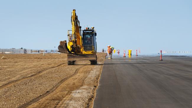 The new runway is built on top of 2.5m of heavily compacted sand, followed by 600mm of crushed rock. Picture: Lachie Millard