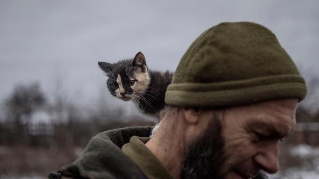 A cat sits on the shoulder of Ukrainian serviceman at a rest house near the front line in the Donetsk region. Picture: Reuters