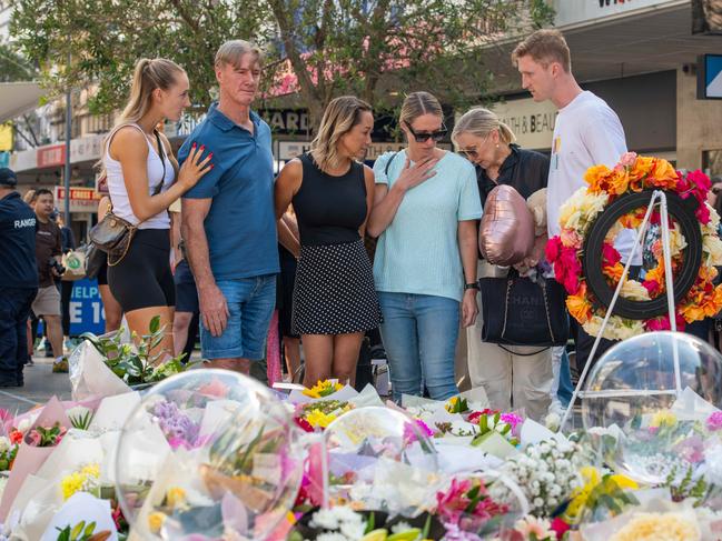 People return to the shop to bring flowers and show their respect. Family of Ashlee Good pictured. Picture: Thomas Lisson