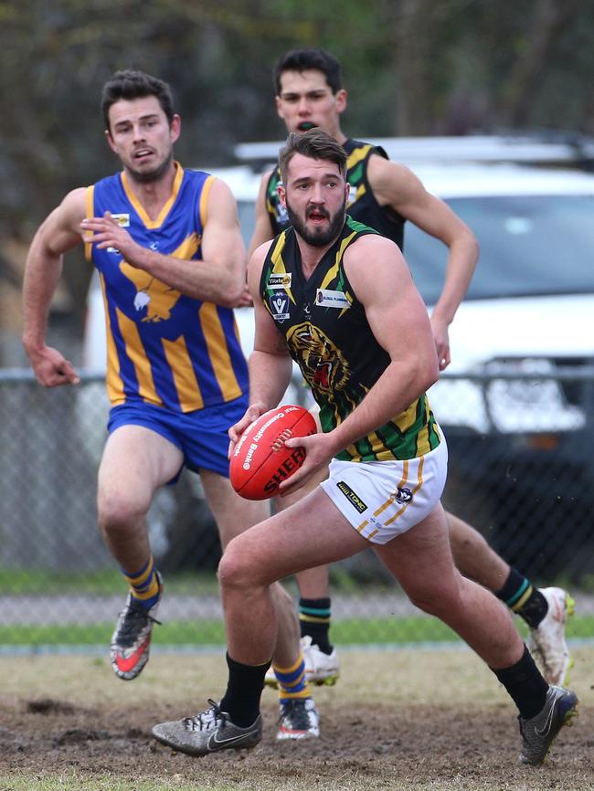 Dromana’s Rohan Bleeker looks for an option up the ground against Somerville. Picture: Hamish Blair