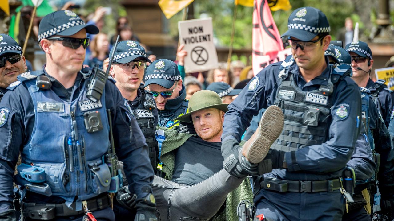 Extinction Rebellion protesters are arrested after a blockade at the corner of Spring and Collins Streets in Melbourne. Picture: Jake Nowakowski