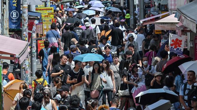 Pedestrians walk down Takeshita Street in the popular area of Harajuku in central Tokyo on July 25, 2024. The number of foreign nationals living in Japan has hit a record high, according to official data released on July 24, that also showed the nation's largest-ever yearly drop in Japanese citizens. (Photo by Richard A. Brooks / AFP)