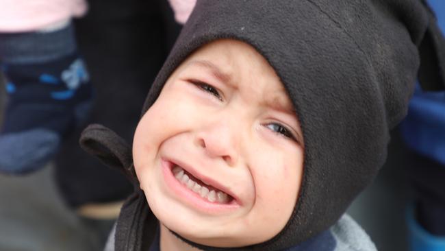 A boy, aged one, cries in the al-Hawl camp.