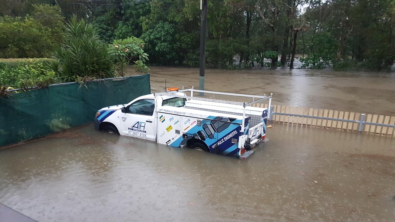 A car in flood water on Baratta St, Southport. Picture: Steve Holland