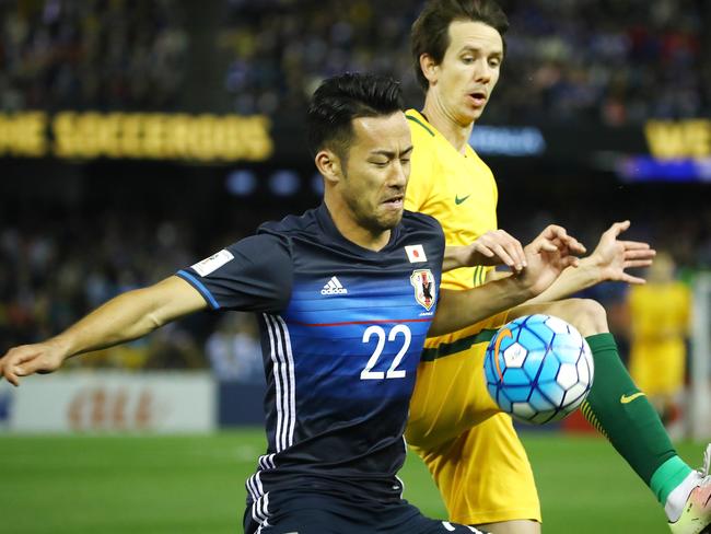 Maya Yoshida keeps calm with Robbie Kruse breathing down his neck.