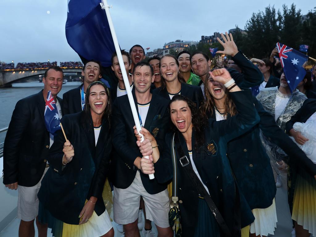 PARIS, FRANCE - JULY 26: Jessica Fox and Eddie Ockenden, Flagbearers of Team Australia, pose for a photo with the national flag on a boat along the River Seine during the opening ceremony of the Olympic Games Paris 2024 on July 26, 2024 in Paris, France. (Photo by Quinn Rooney/Getty Images)