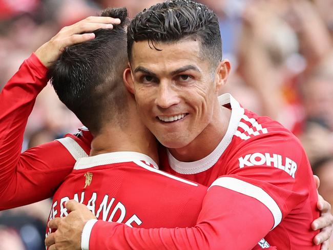 MANCHESTER, ENGLAND - SEPTEMBER 11: Bruno Fernandes of Manchester United celebrates with Cristiano Ronaldo after scoring their side's third goal during the Premier League match between Manchester United and Newcastle United at Old Trafford on September 11, 2021 in Manchester, England. (Photo by Clive Brunskill/Getty Images)