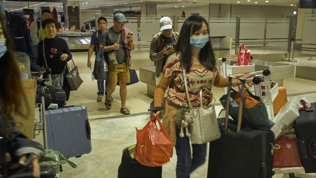 Passengers from China arrive at Ninoy Aquino International Airport in Manila. The Philippines and other Asian countries are on high alert following the outbreak of a new strain of coronavirus from Wuhan. Picture: Getty Images