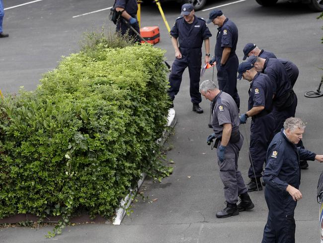 Police search for evidence in the grounds of a motel near the Masjid Al Noor mosque in Christchurch. Picture: AP