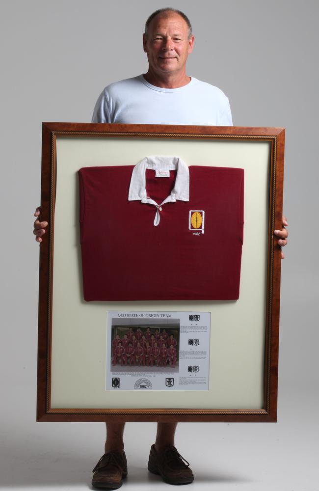 Greg Holben, who played for Queensland in 1982, holding his framed jersey.