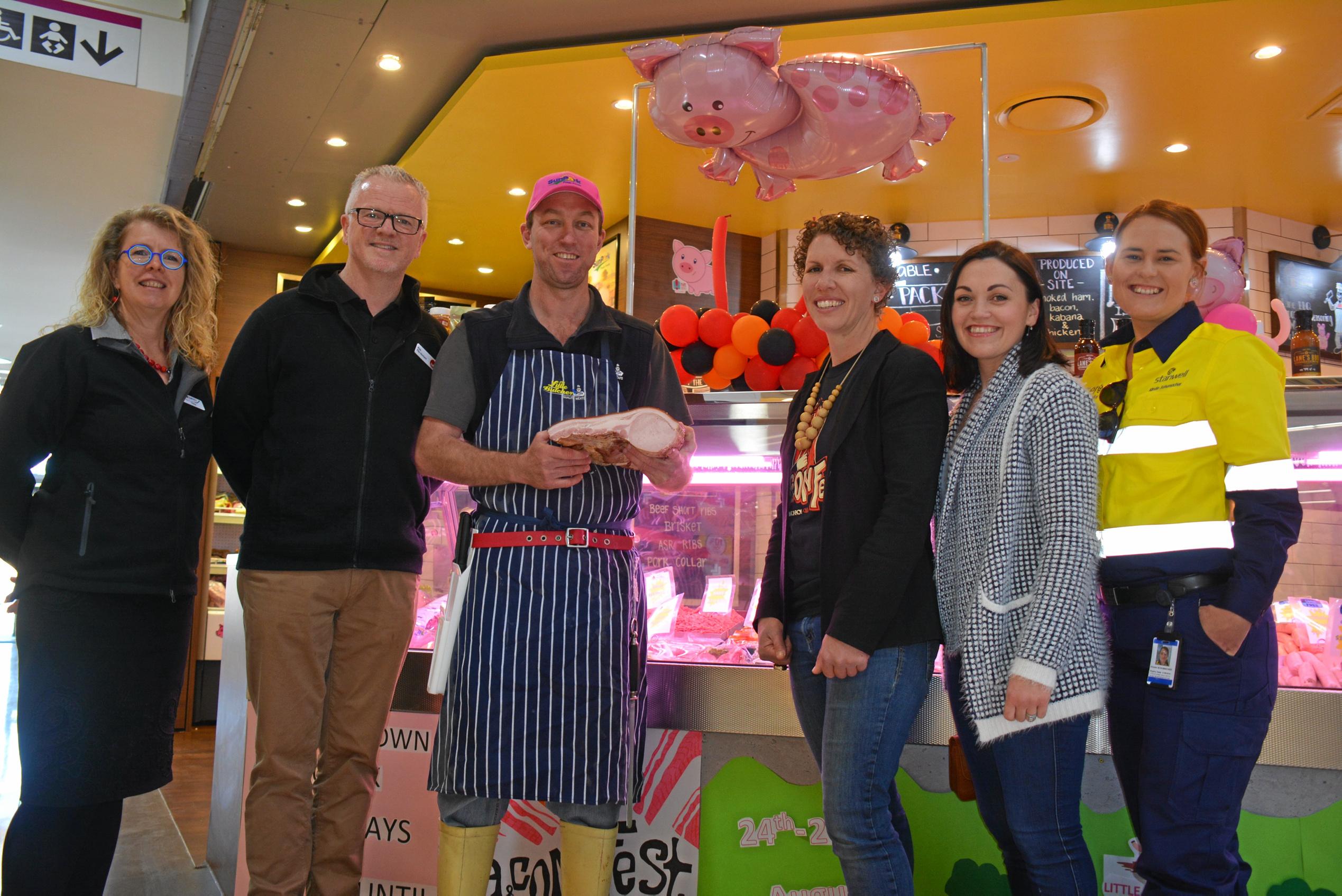 WINNING CUT: Tonia Gilbert, Rob Fitz-Herbert, Clinton Stretton, Kath Stevens, Felicity Cavill and Kirstie Schumacher outside Kingaroy Little Butcher's winning BaconFest shop front. Picture: Jessica McGrath