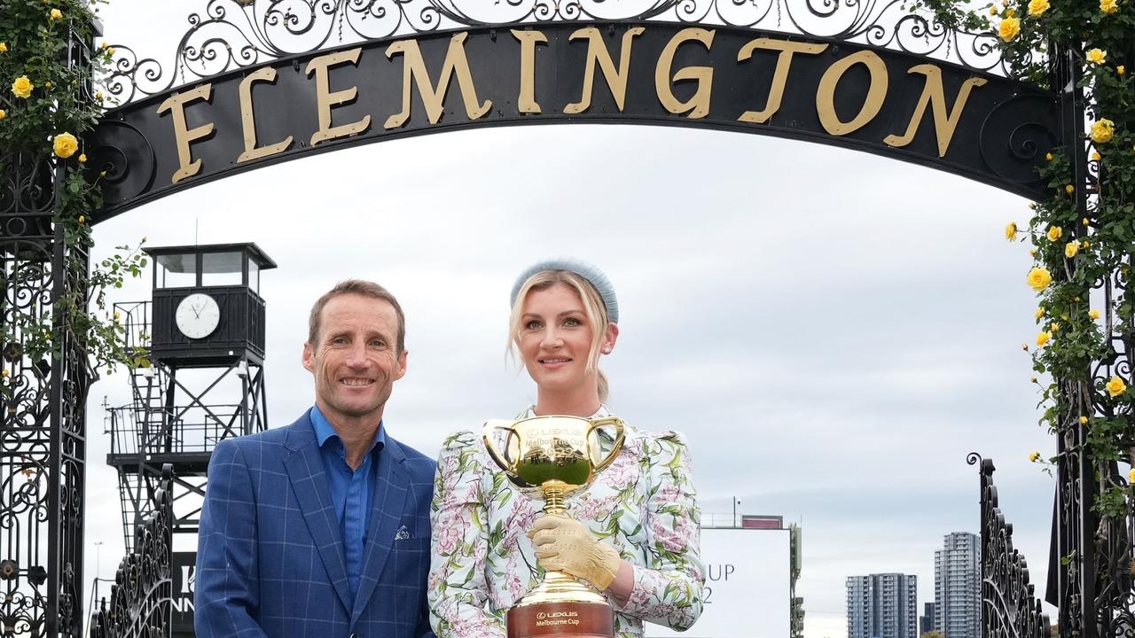 Damien Oliver and Jamie Kah pose with the Melbourne Cup during the Melbourne Cup Carnival Launch at Flemington Racecourse on October 24, 2022 in Flemington, Australia. (Photo by Scott Barbour/Racing Photos via Getty Images)