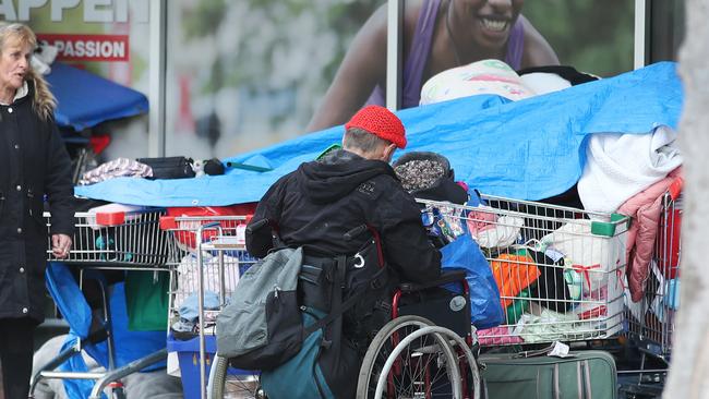 Homeless store their belongings under a giant tarp outside the entrance to Southport TAFE in the middle of town at Nerang St Southport. Picture Glenn Hampson