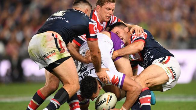 Three Chooks in the tackle slow the play the ball down. Picture: AAP