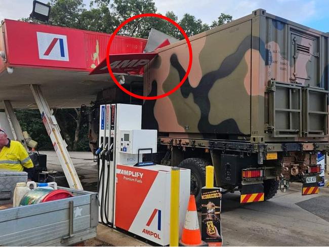 Army truck drives through servo roof