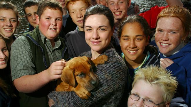 Vanessa Amorosi and her great dane puppy Mr Burns with Year 8 and 9 students from Koonung Secondary College promoting The Kids Help Line Benefit Auction Dinner in 2003.