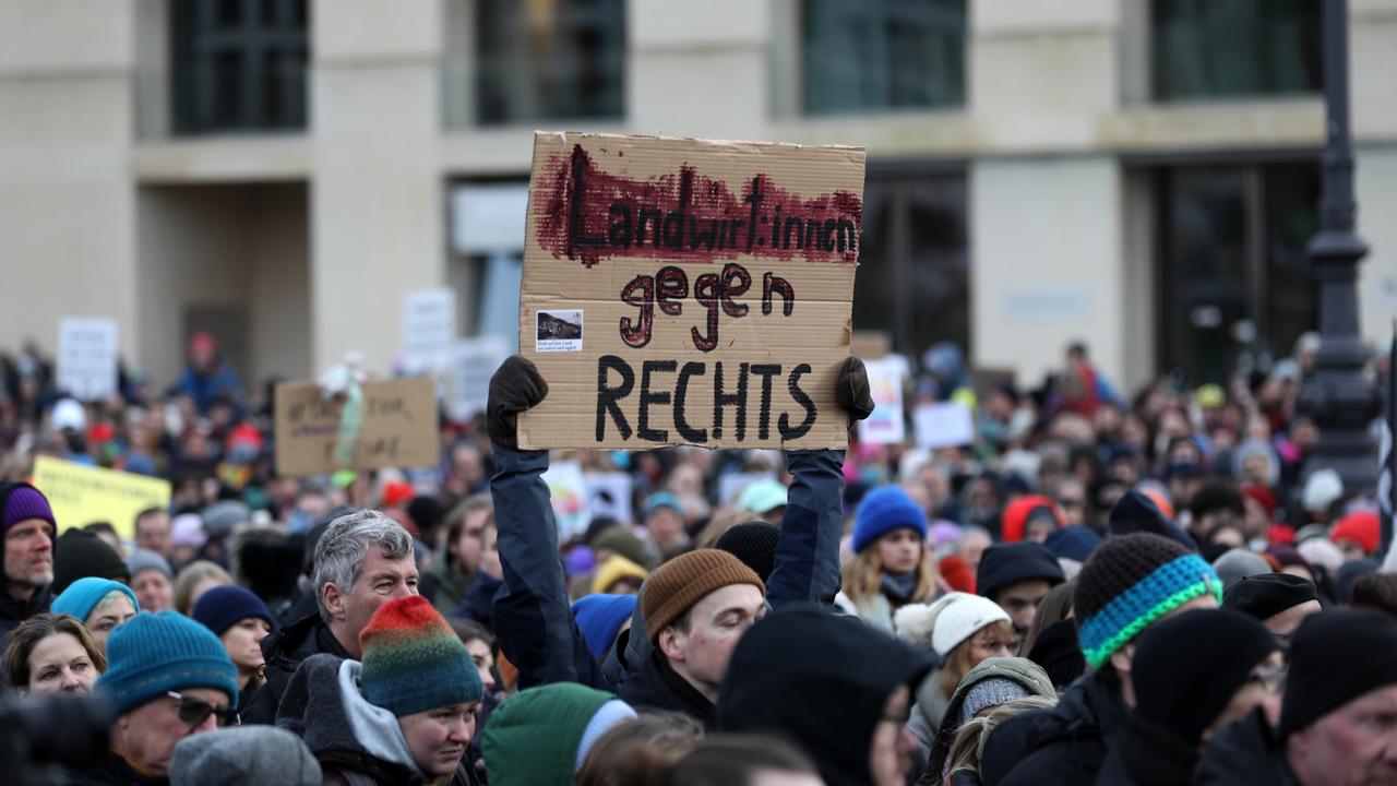 A girl holds a sign reading, "farmers against right extremism" as far right groups become involved in farmers’ protests in Germany. Picture: Maryam Majd/Getty Images.