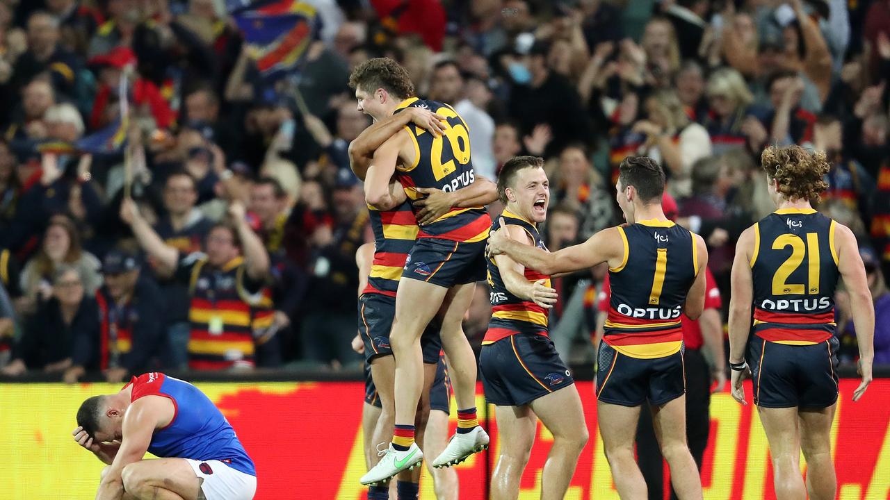 Crows players celebrate their upset of Melbourne in 2021. Picture: Sarah Reed/AFL Photos via Getty Images