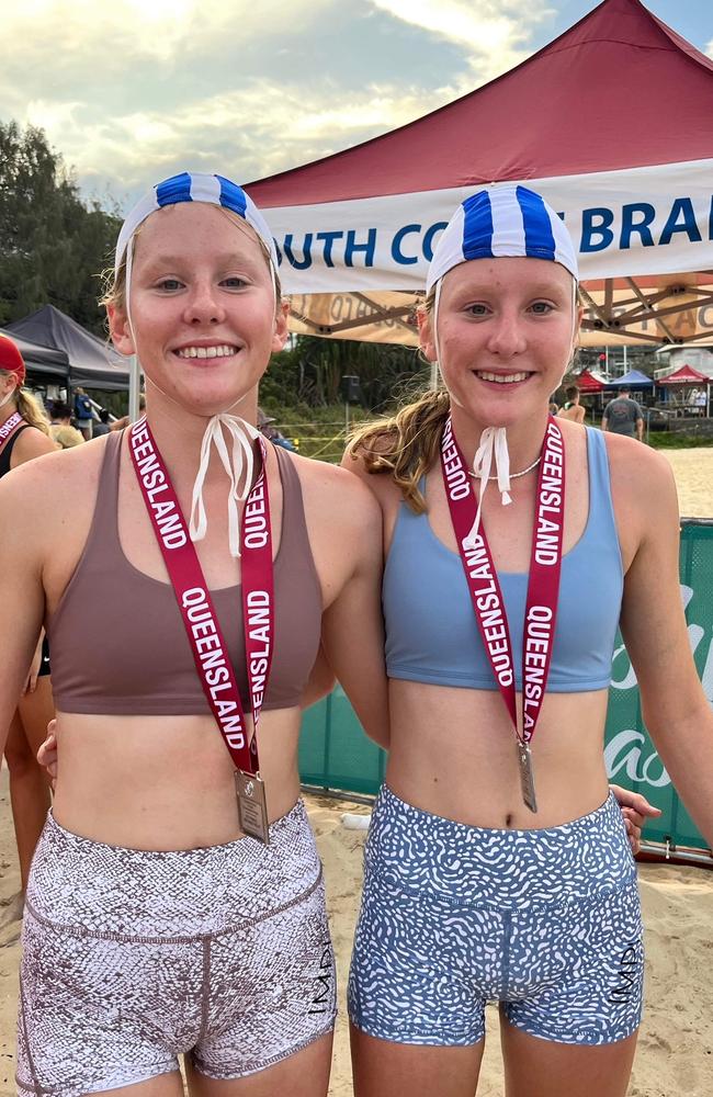 Under-15 competitors and twin sisters Abbie and Caitie Penny from Picnic Bay taking the silver in the U15 2 x 1km beach relay competing for North Barrier Branch at the 2023 Youth Surf Life Saving Championships at Mooloolaba.