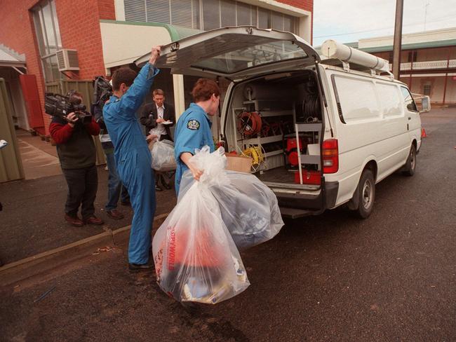 Forensic officers removing evidence from the old State Bank building at Snowtown. Picture: Mark Brake