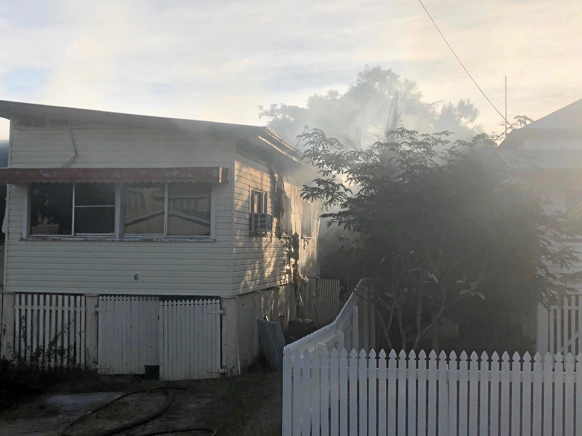 Firefighters at the scene of a house fire on Naughton St, Wandal, this afternoon. Reports indicate the top part of the house is gutted but firefighters are walking in through the front door.