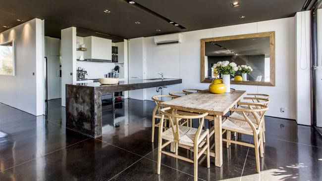 The kitchen’s handcrafted concrete island bench adds to its edgy appeal.