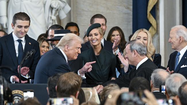 President Donald Trump, left, points to Supreme Court Chief Justice John Roberts after taking the oath of office.