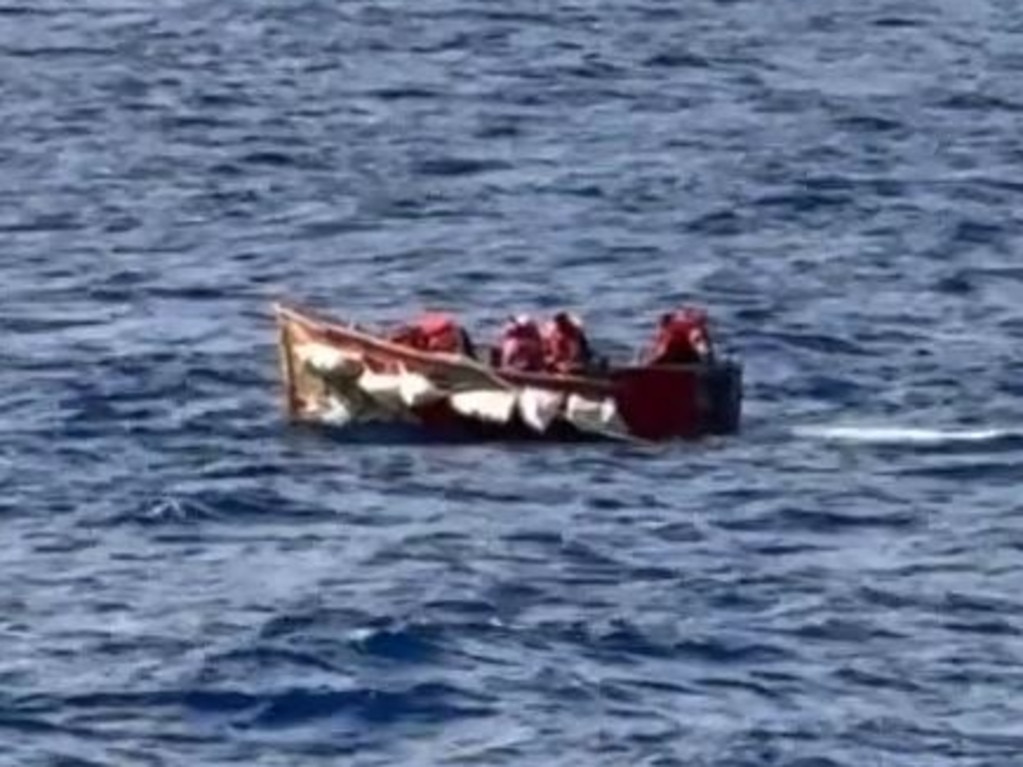 The refugee boat could be seen in distress waving white flags and dumping out water from the sinking shift while adrift in The Gulf of Mexico, according to a passenger on the LGBTQ+ cruise which saved them.