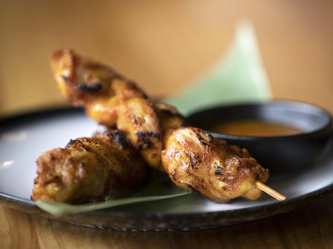 Bite Me’s Satay Chicken Skewers feature tasty, tinged-turmeric satay sauce. Picture: Chris Kidd