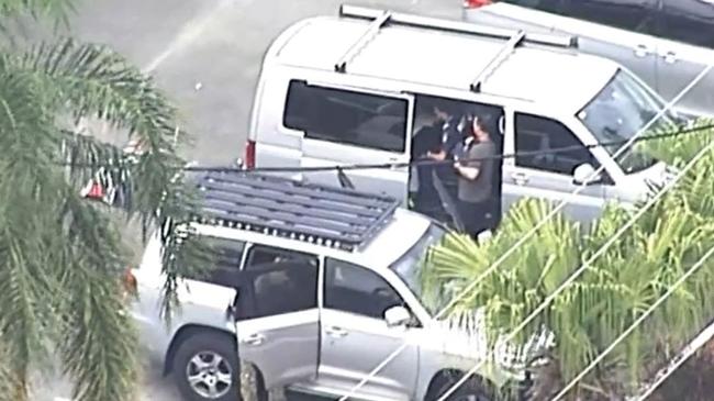 Heavily armed police officers search for a suspected gunman. Picture: Nine News.