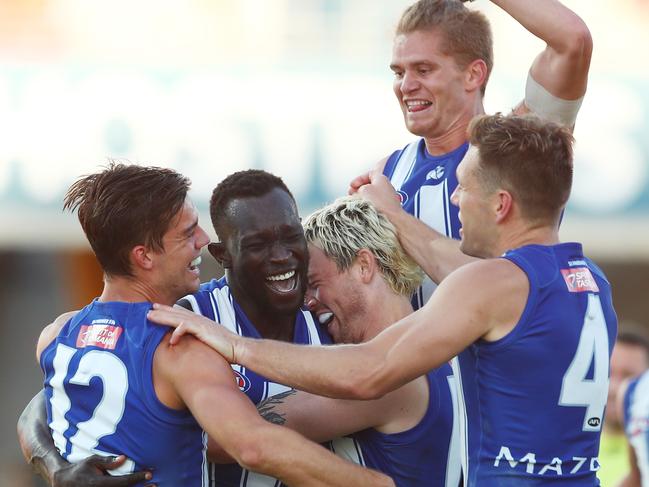 Majak Daw of the Kangaroos celebrates a goal with teammates.