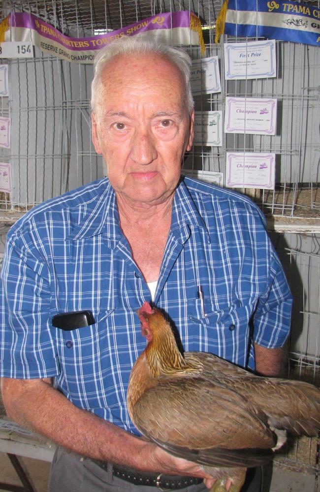 Stewart Macdonald shows off Neville Wise's large partridge hen, which won the grand champion prize in the pigeon and poultry category at the 2009 show in Charters Towers.