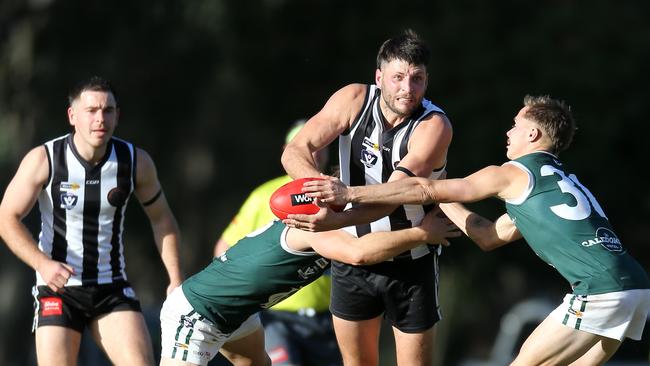 Euroa’s Adam Giobbi battles for the ball with Echuca’s Mitchell Wales and Corbin Anderson.