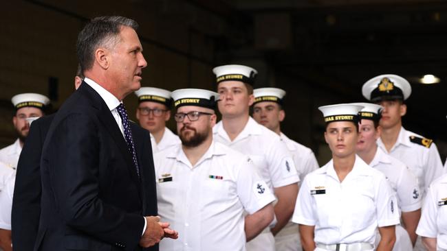 Richard Marles with sailors from the Hobart-class destroyer HMAS Sydney aboard the landing helicopter dock ship HMAS Canberra for this week’s naval plan announcement. Picture: David Gray/AFP