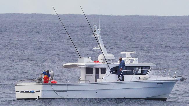 Contractors retrieve and replace damaged shark nets off Surfers Paradise after a successful whale rescue this morning. Picture: Glenn Hampson